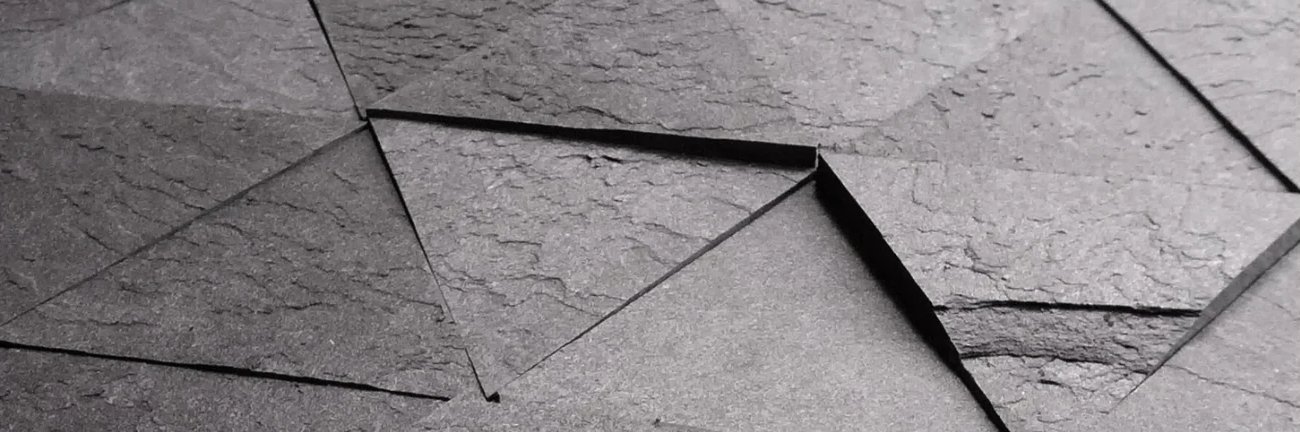 Slatency triangle tiles installed in faceted relief
